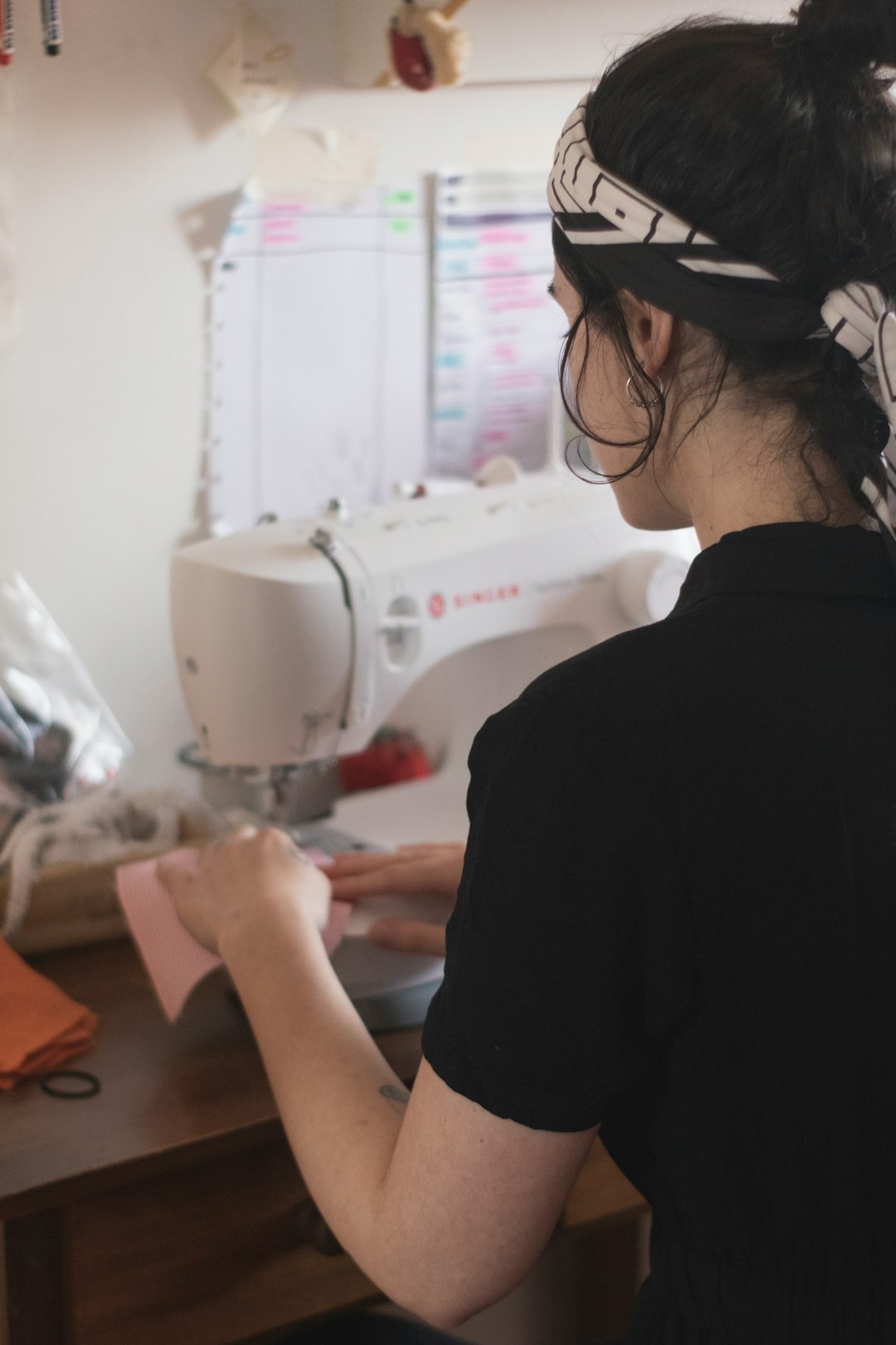 Photo by Marília Castelli man in black shirt using sewing machine